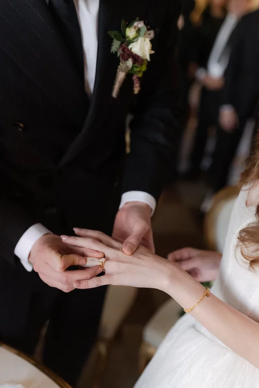 elegant wedding couple exchanging rings during a luxury wedding in a castle in France